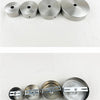 A row of five polished stainless steel ceiling mount canopy discs for pendant lights.