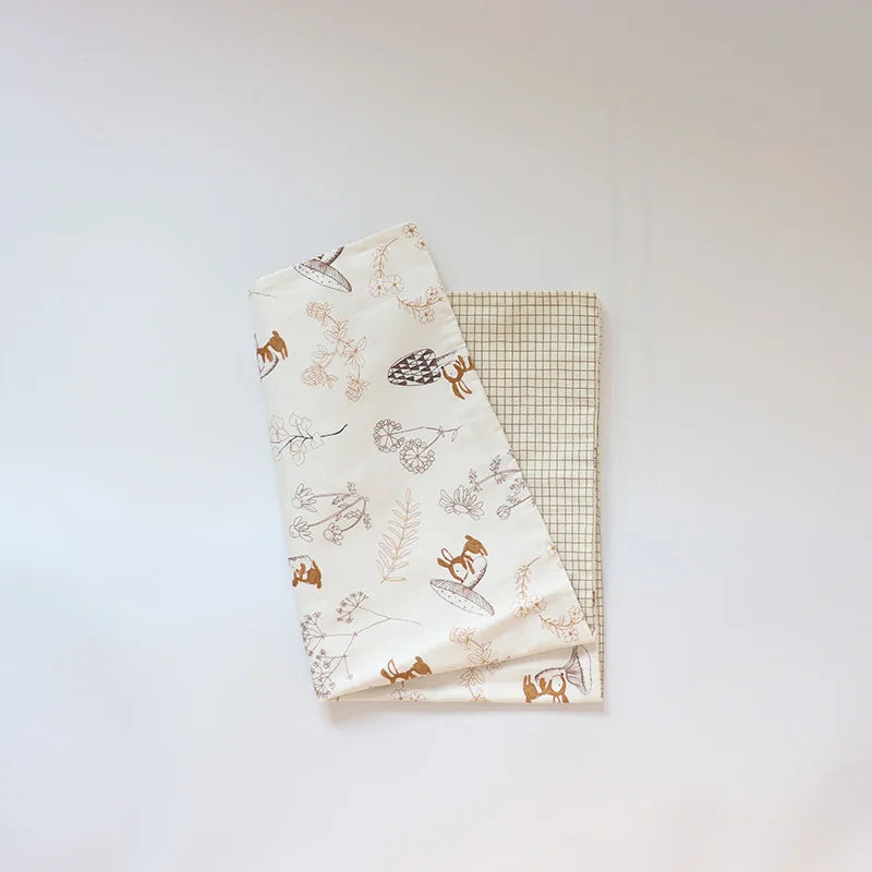 A white soft cotton baby pillowcase featuring a cartoon design of woodland animals and foliage.