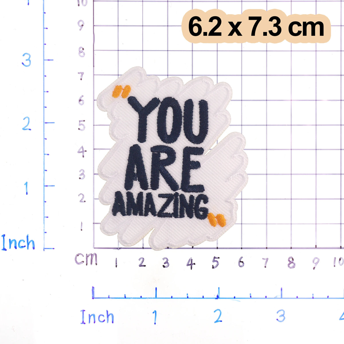 White embroidered patch with black text YOU ARE AMAZING and small orange accents