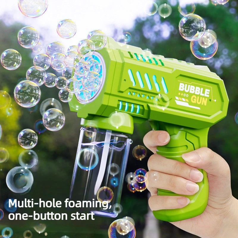 A hand holds a green multi-hole foaming bubble gun with colorful lights, shooting bubbles against a blurred green background.