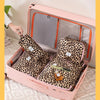 A pink toiletry box is open, revealing a leopard print storage bag filled with toiletries.