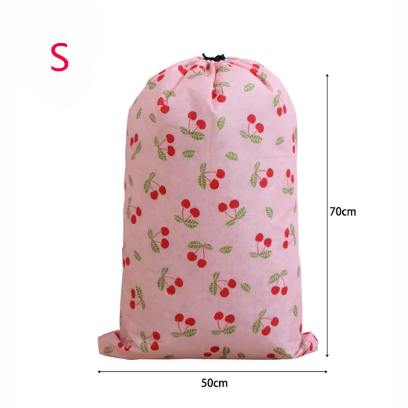 Pink drawstring laundry bag with a pattern of red and green berries