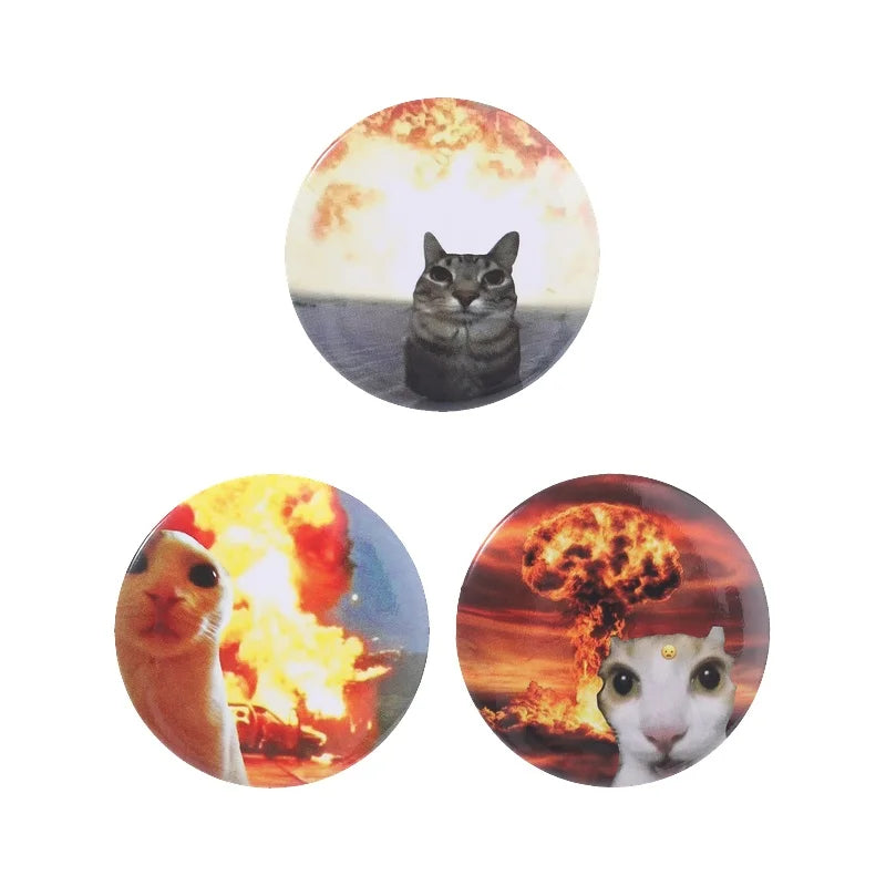 A set of three round pins featuring cats against fiery backgrounds.
