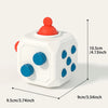 A white sensory ball toy with an orange top is shown from a top-down angle, displaying its size.