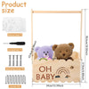 A wooden baby shower crate featuring a teddy bear and rainbow design, with accompanying instructions and screws.