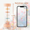 A wooden rain drops rattle toy measuring 6.29 inches next to an iPhone 14 for scale.