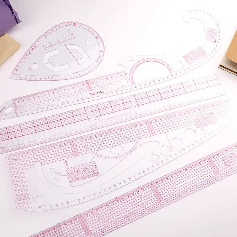 A set of six flexible sewing rulers and templates for French curve stitching, pink and white.