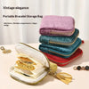 A stack of velvet bracelet storage bags in various shades of purple and blue, with an open bag displaying gold jewelry.