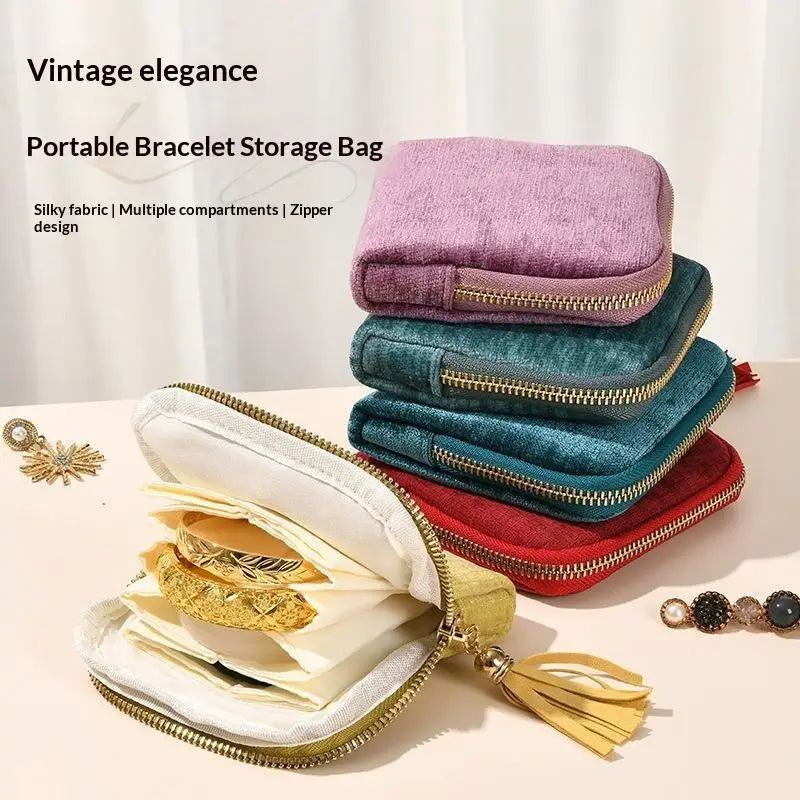 A stack of velvet bracelet storage bags in various shades of purple and blue, with an open bag displaying gold jewelry.