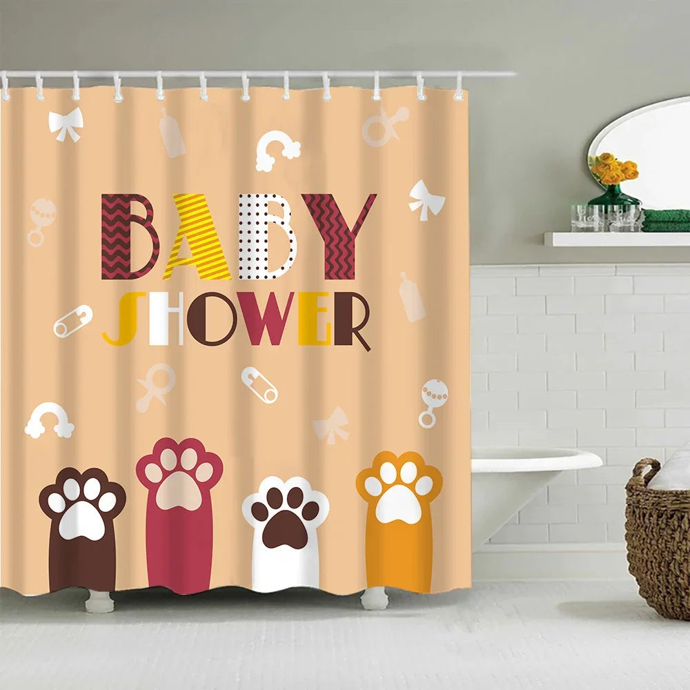 A shower curtain featuring cute cartoon paw prints and various baby shower symbols in pink, yellow, and red tones.