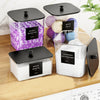 Three clear plastic storage containers with black lids hold laundry items like dryer balls and detergent sheets.