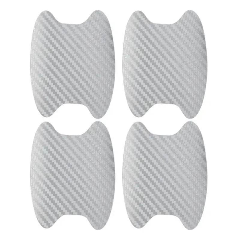 A pack of four carbon fiber protective covers for car door handles.