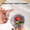 A hand holds an elastic beam tightly wrapped disposable sink drain filter containing leafy greens and a tomato.