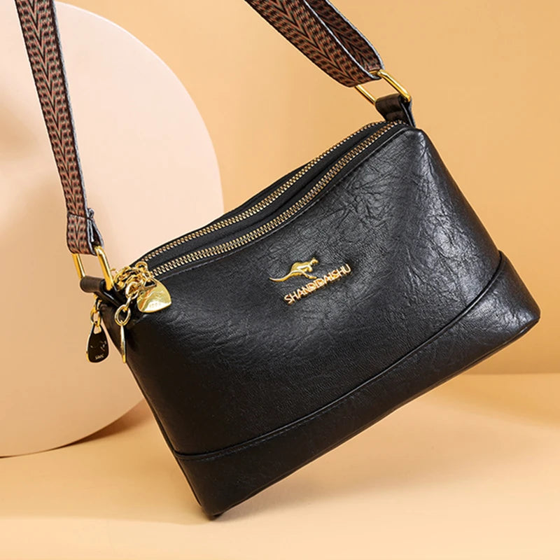 A black PU leather crossbody shoulder bag with a brown patterned strap and gold hardware.