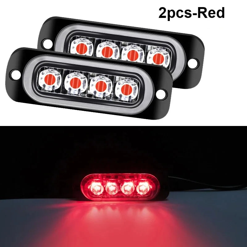 Two red LED strobe side marker lights mounted on a vehicle, showing the bright red illumination.