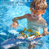 A young boy playing in a swimming pool while operating a remote control shark toy that sprays water.