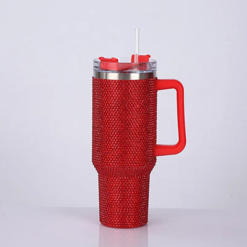 A red rhinestone bling tumbler with a straw and handle is shown against a white background.