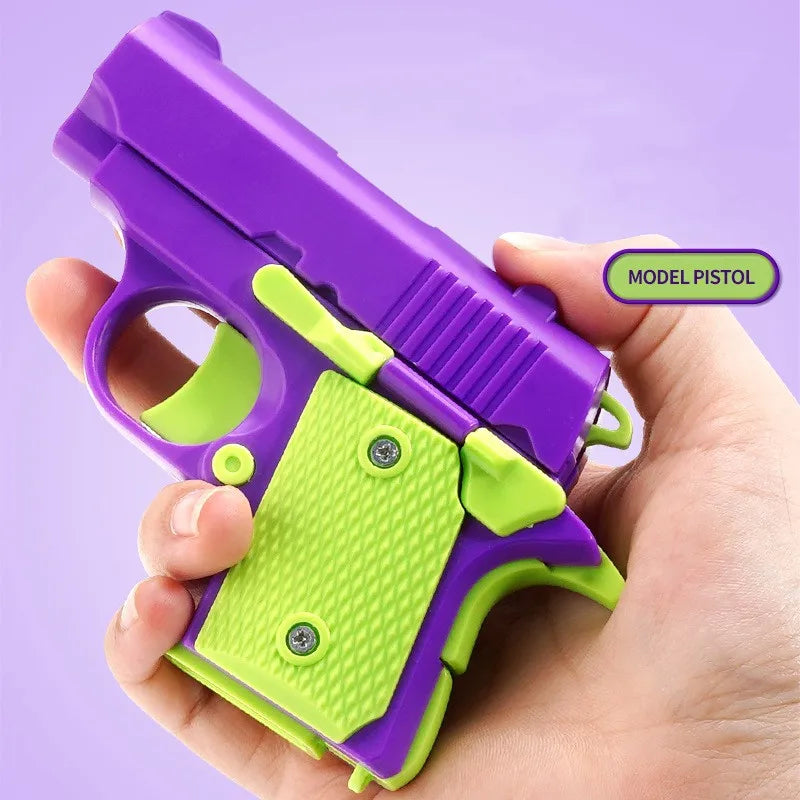 A hand holds a purple and lime green mini 3D printed gravity fidget pistol toy.