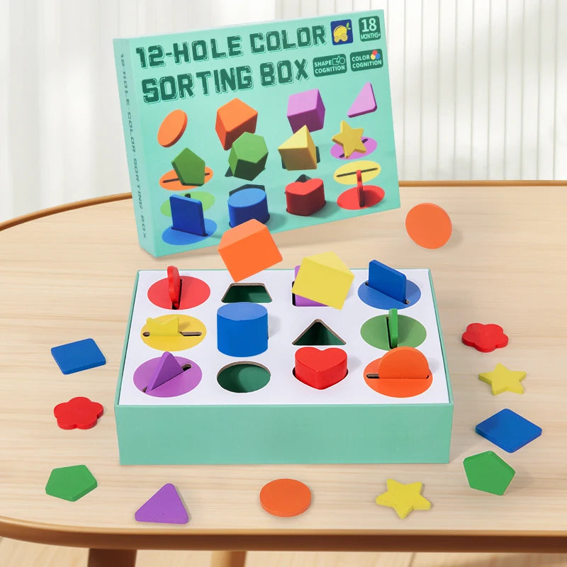 A green sorting box filled with colorful geometric shapes for toddlers, displayed on a wooden table.