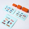 A set of orange RC car decorative accessories including surfboard, kayak, and roadblocks.