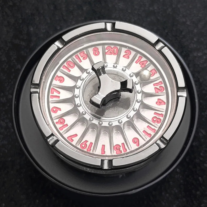 Close-up view of a metal roulette dice with numbered fingers for tabletop games
