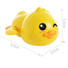 A bright yellow wind-up bath toy duck with a smiling face and orange beak.