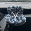 A fluffy blue faux fur doll seat car vent decoration with a white tie closure.