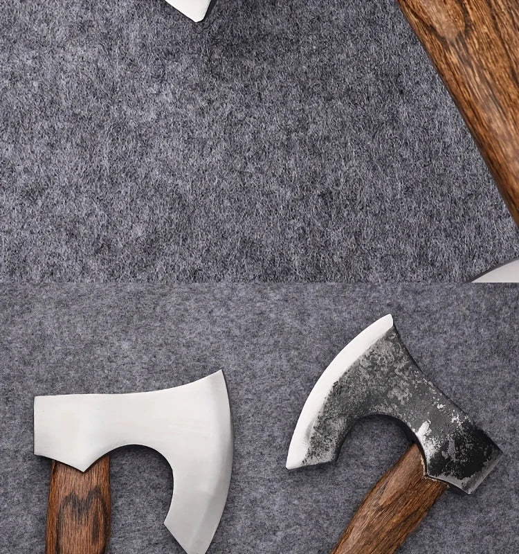 A hand-forged Viking tomahawk axe with a white blade and wooden handle resting on a gray textile surface.