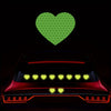 A red car with glowing yellow lights and a green heart sticker above it.