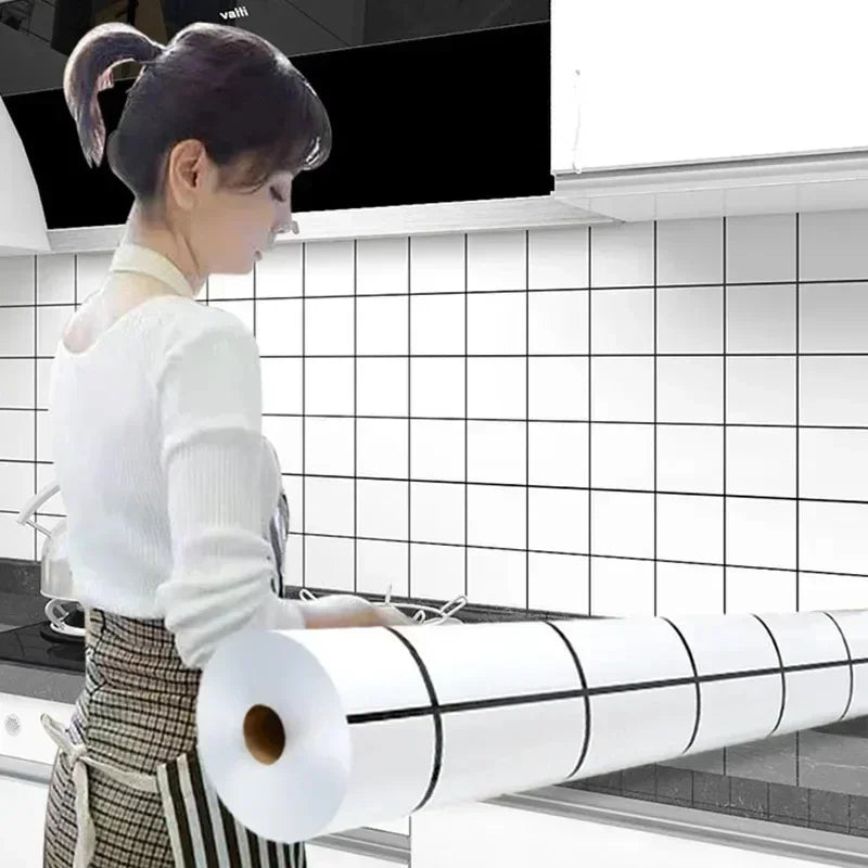A woman is applying a roll of white self-adhesive kitchen splashback sticker to a tiled wall.