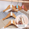 A wooden hanger with a white connector is shown hanging on a wooden rod, demonstrating double-sided hanging capability.