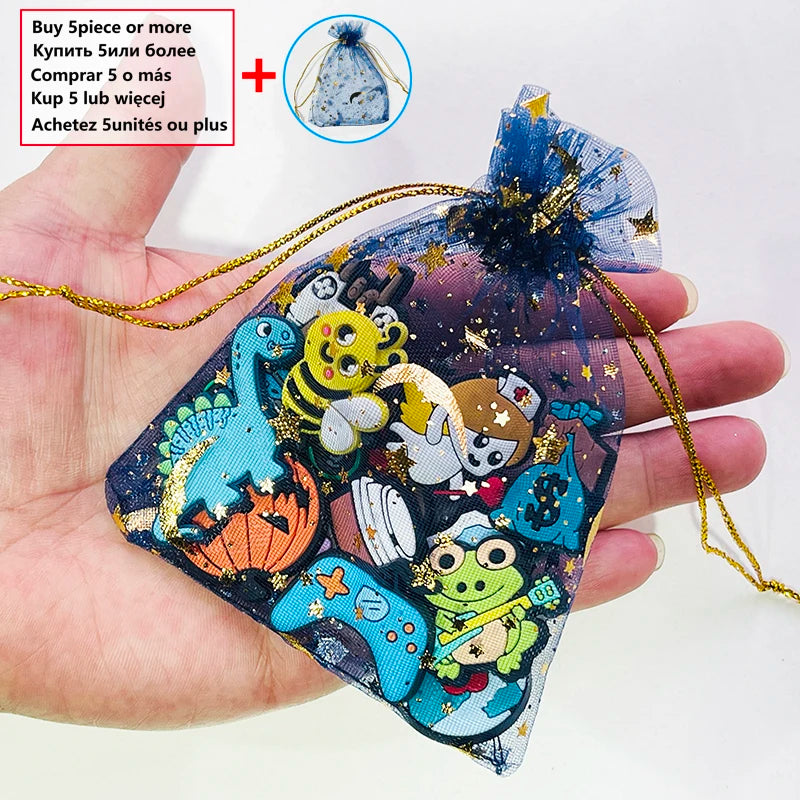 A hand holds a clear pouch filled with colorful PVC charms and pins for shoe decoration.