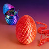 A set of 3D printed dragon egg and figurine, featuring a vibrant red textured egg and a blue patterned container.