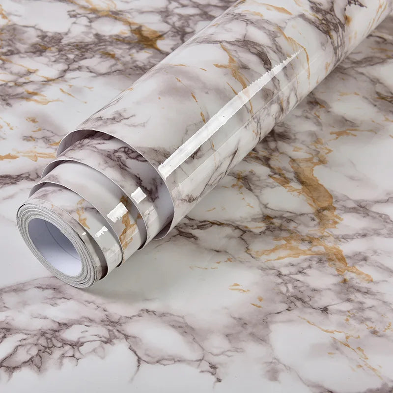 Roll of marble contact paper featuring white and gold veining on a white background
