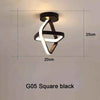 A black square modern LED ceiling light fixture with a white, stylized clover shape.