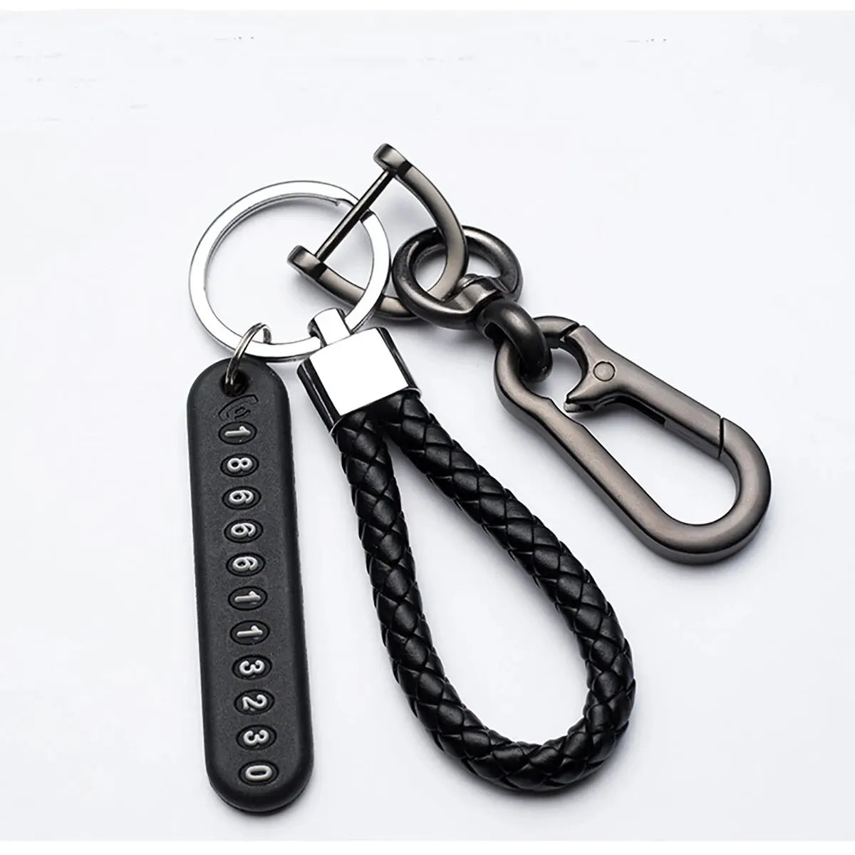 A black personalized phone number keychain featuring a braided leather rope and metal hardware.