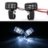 A pair of black LED headlight and spotlight units for RC crawler trucks, showing a bright beam.