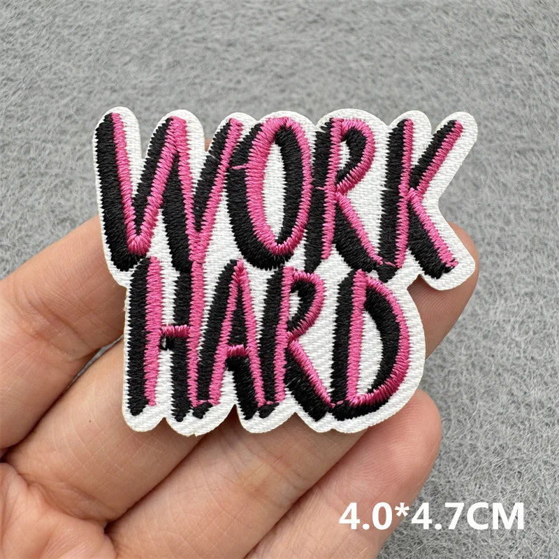Black and pink embroidered patch with the text WORK HARD on a hand