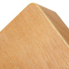 A close-up view of a light wood compact travel cajon drum with a slanted top edge.