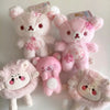 A collection of pink and white cherry blossom plush bear keychains.