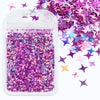 A clear plastic pouch filled with iridescent purple and pink holographic star sequins for resin crafts.