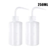 Two clear plastic squeeze bottles with precision tips for tattoo ink or liquid application