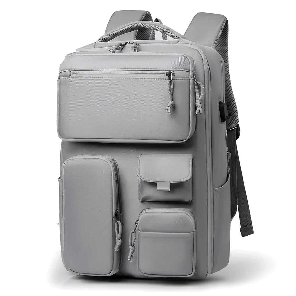 A gray travel backpack with a laptop compartment and multiple storage pockets.