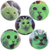 A collection of playful tinplate pin badges featuring various cat faces and animal memes in shades of green.
