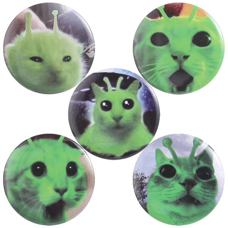 A collection of playful tinplate pin badges featuring various cat faces and animal memes in shades of green.
