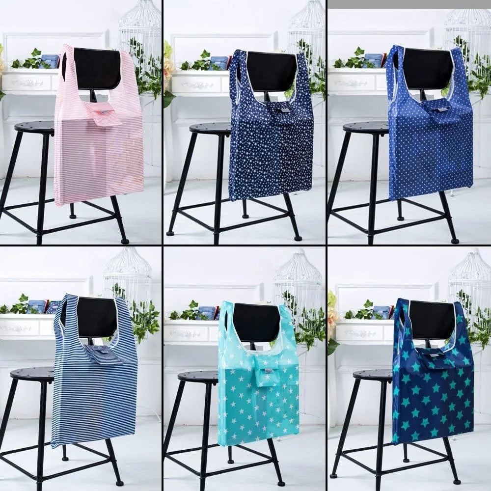 A collection of compact foldable tote bags in various colors and patterns displayed on black stands.