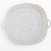 White reusable square air fryer silicone liner with a geometric pattern.