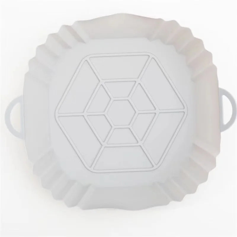 White reusable square air fryer silicone liner with a geometric pattern.