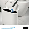 A disposable toilet cleaning brush with a storage base and sponge is shown next to a white toilet bowl.