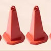 A set of red decorative accessories for an RC car, including surfboard, kayak, and roadblocks.